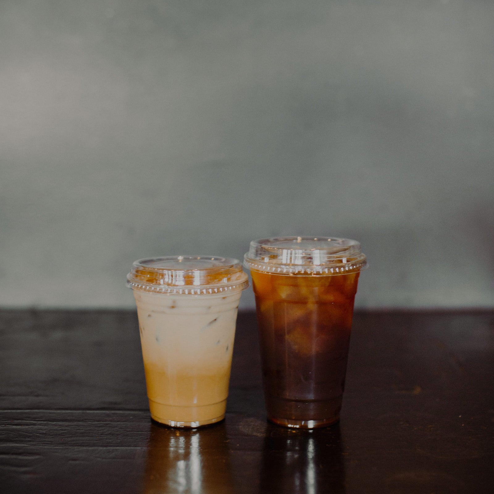 Iced coffee and latte served in clear to-go cups at Cottonwood Coffee, showcasing refreshing and flavorful beverage options.