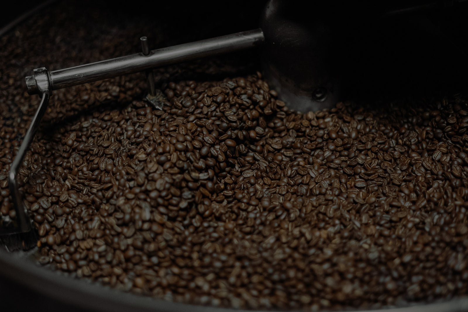 Coffee beans being roasted in a professional roaster at Cottonwood Coffee, showcasing the dedication to quality and freshness.